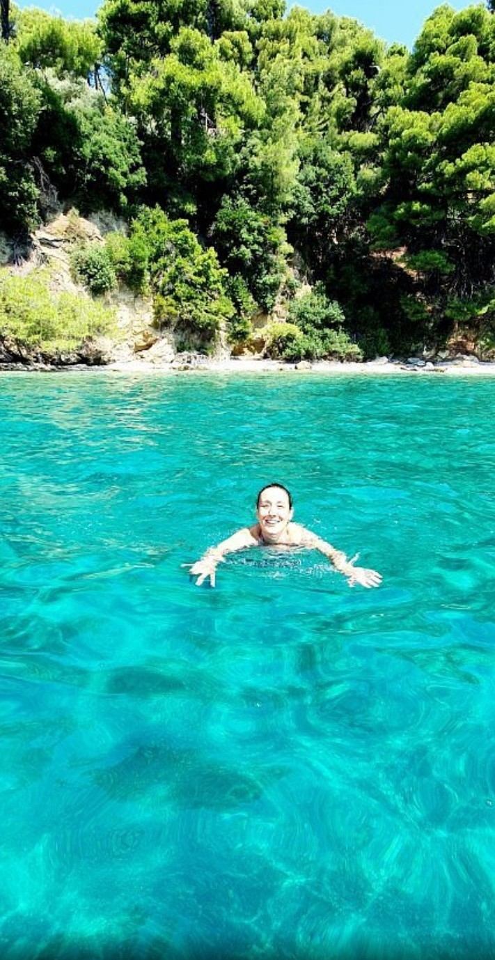 Swimmer floating in bright turquoise water